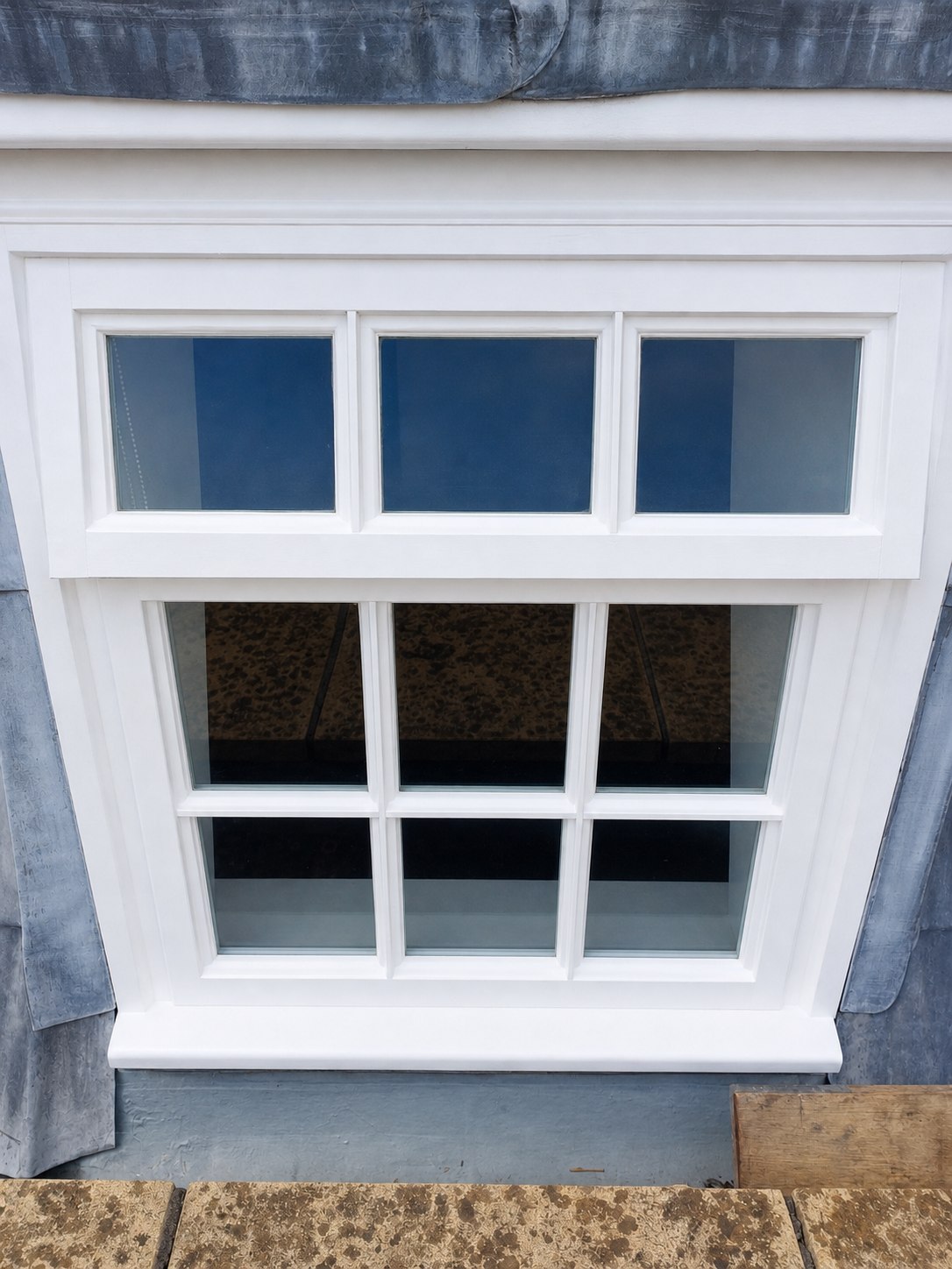 Generated restored version of the same sash window from the same straight-on angle, with fresh white paint and repaired timber.